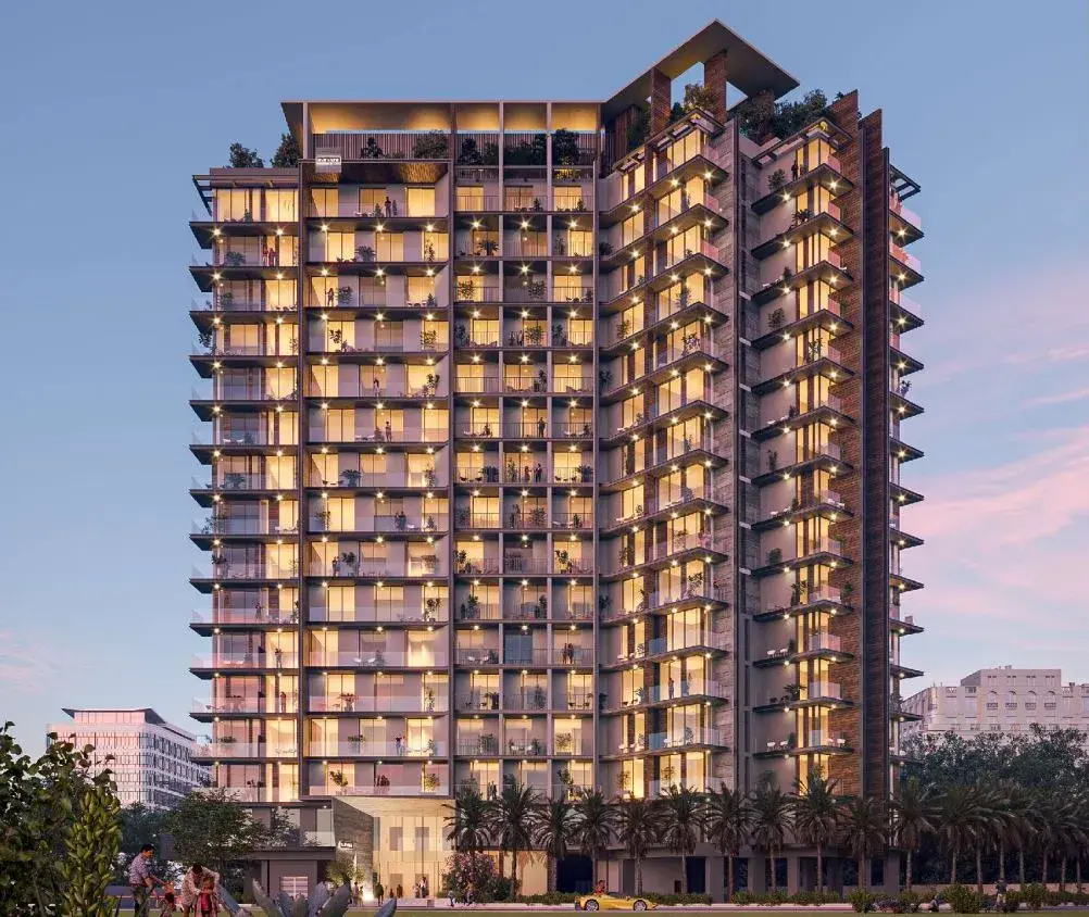 Tower at dusk with lit windows and palms
