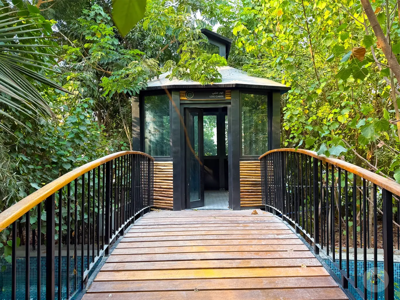 Log cabin reached by a wooden bridge