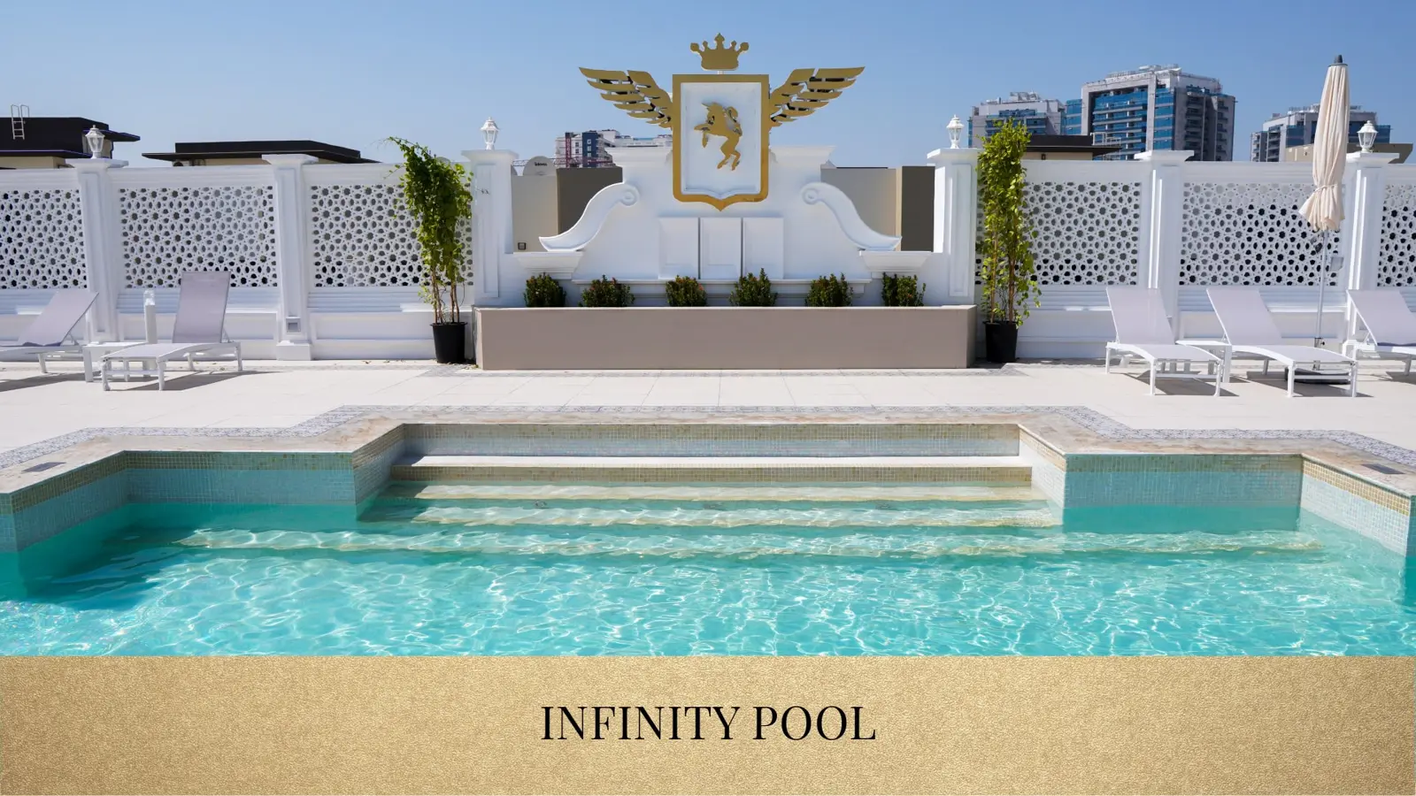 Infinity pool with sun loungers on the roof deck