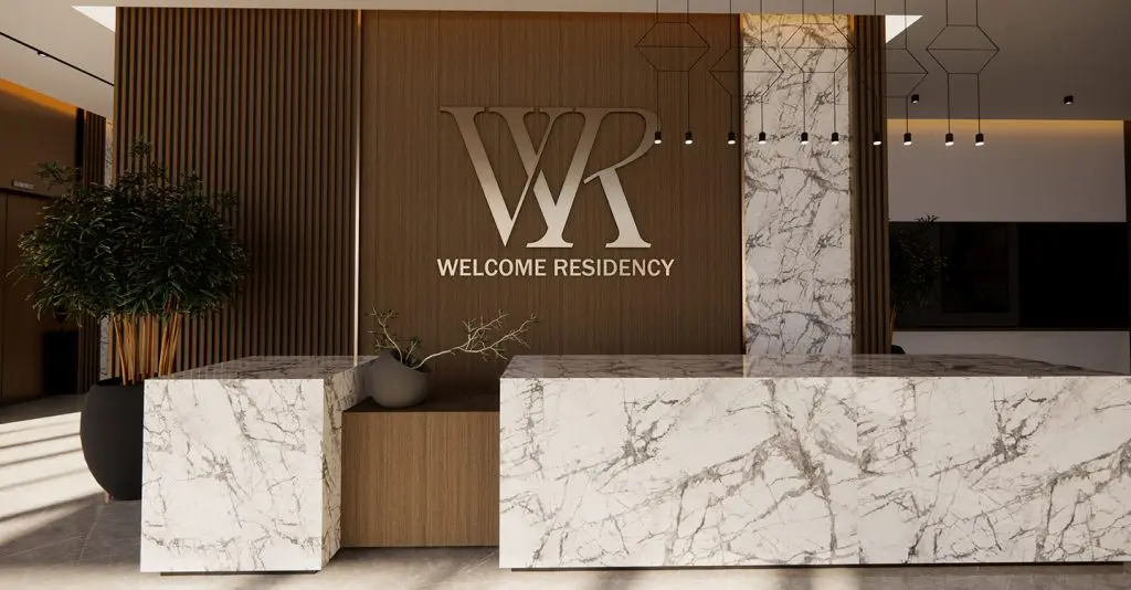 Lobby reception with marble desk and Welcome Residency logo