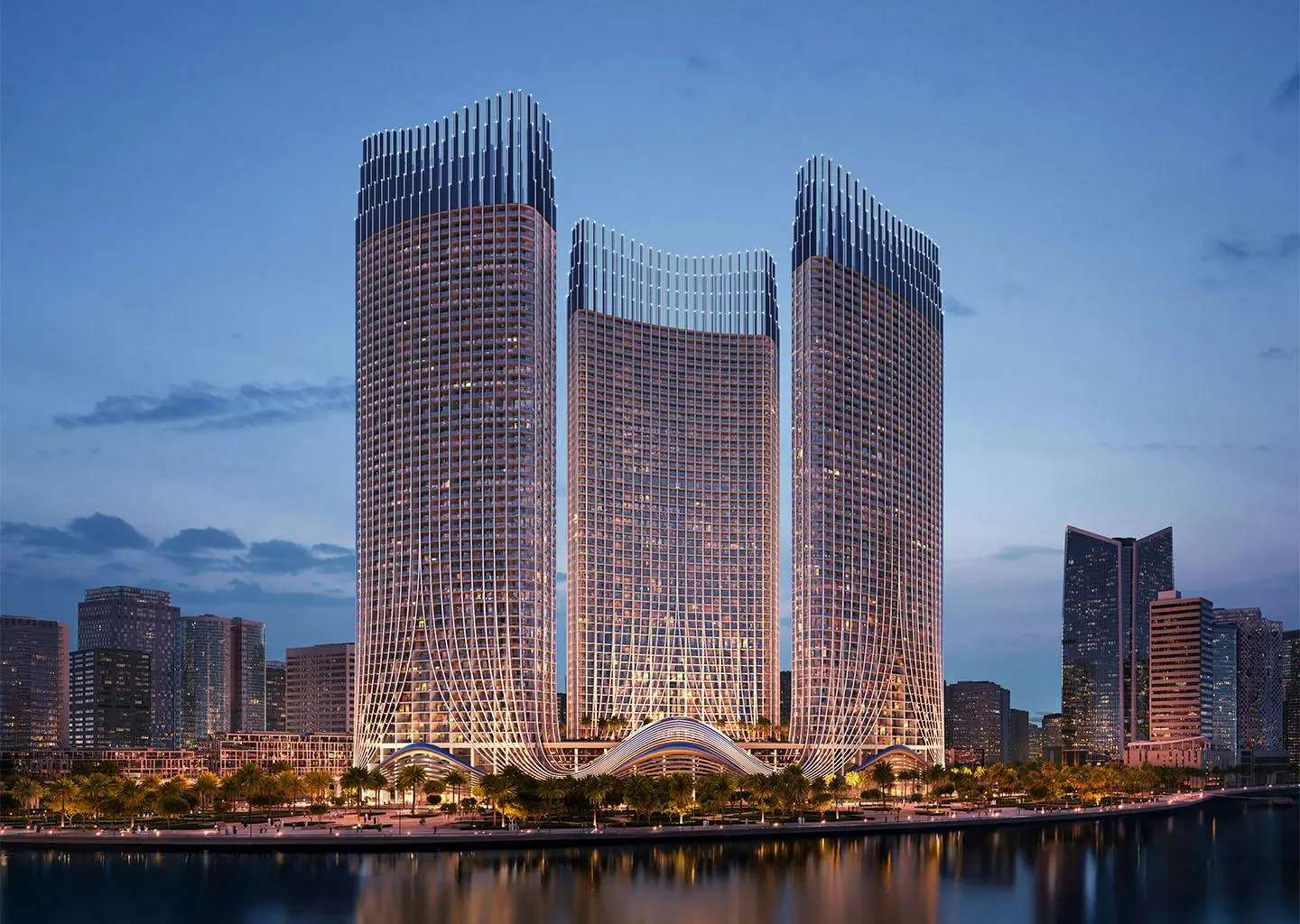 Three towers by the water at dusk