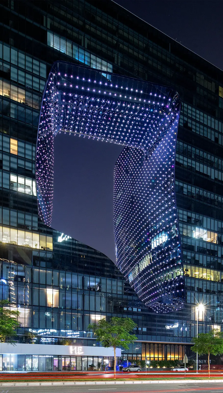 Illuminated void at night from street level