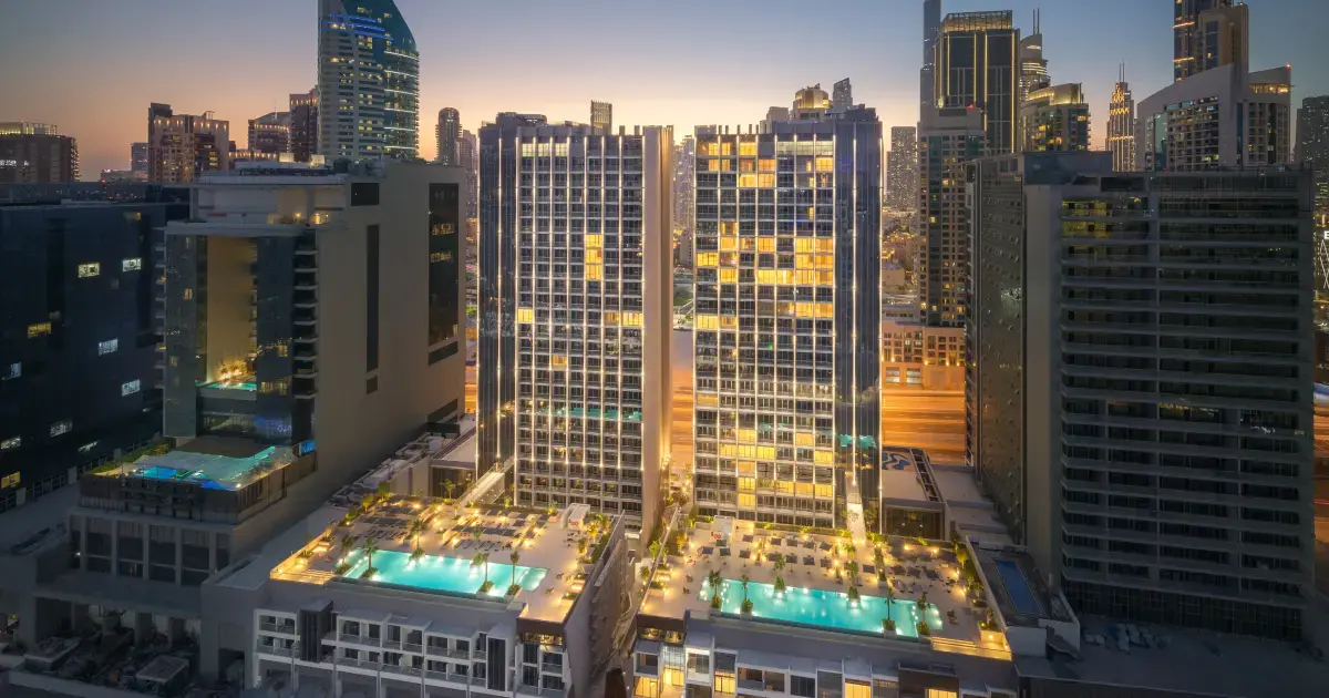 Twin towers at sunset with two rooftop pools