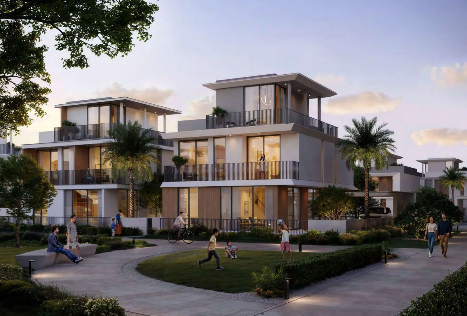 Villas with balconies and families on a green lawn