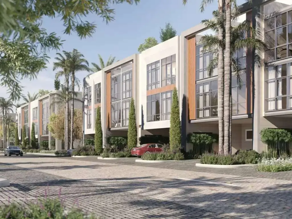 Townhouse row along paved street with palms