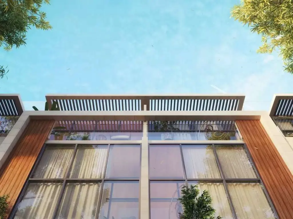 Townhouse facade seen from below against sky