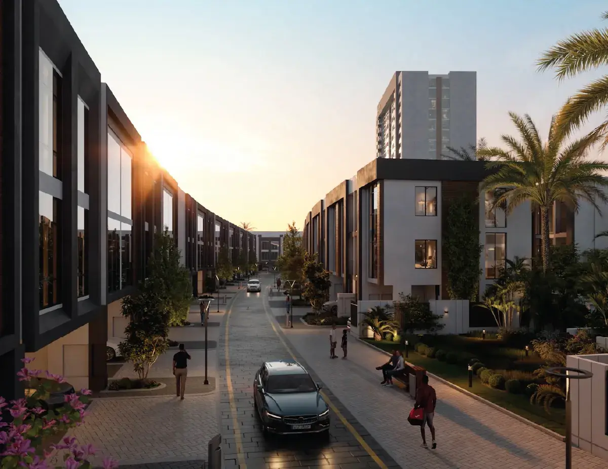 Townhouse street at sunset with a tower behind