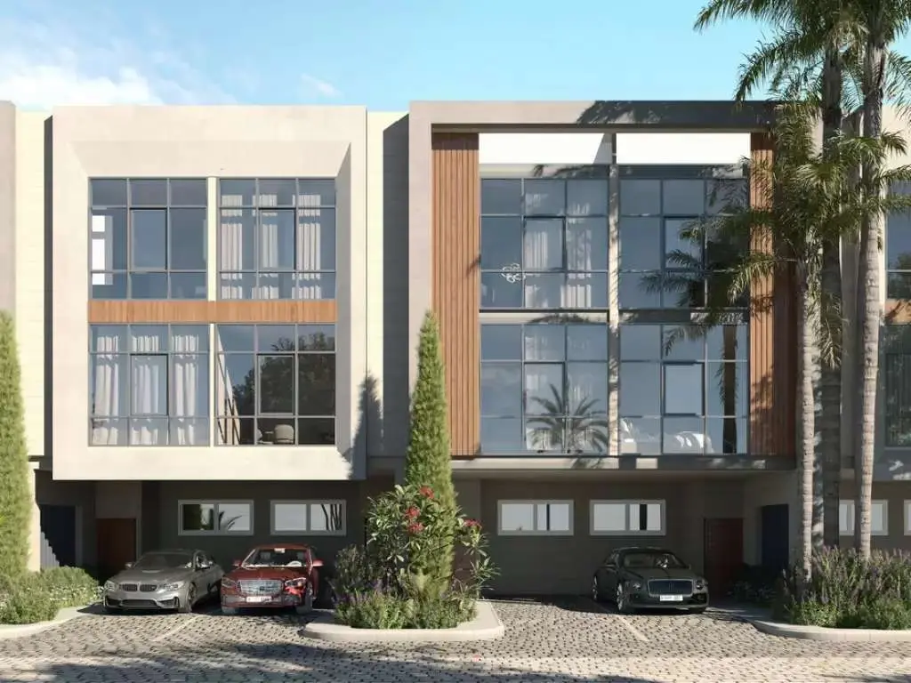 Three-storey townhouse facade with parked cars