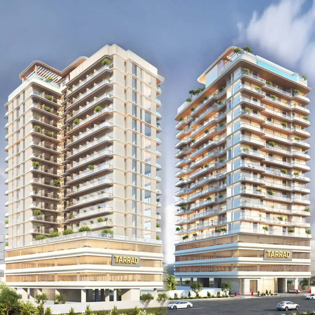 Two residential towers on a shared podium with Tarrad signage