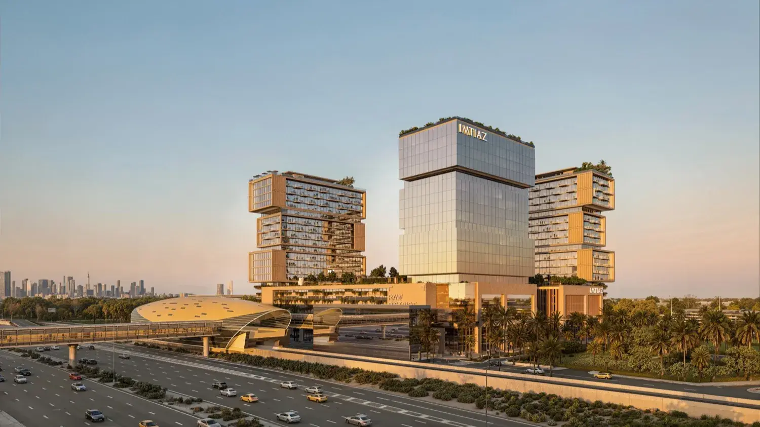 Three towers beside the metro with skyline