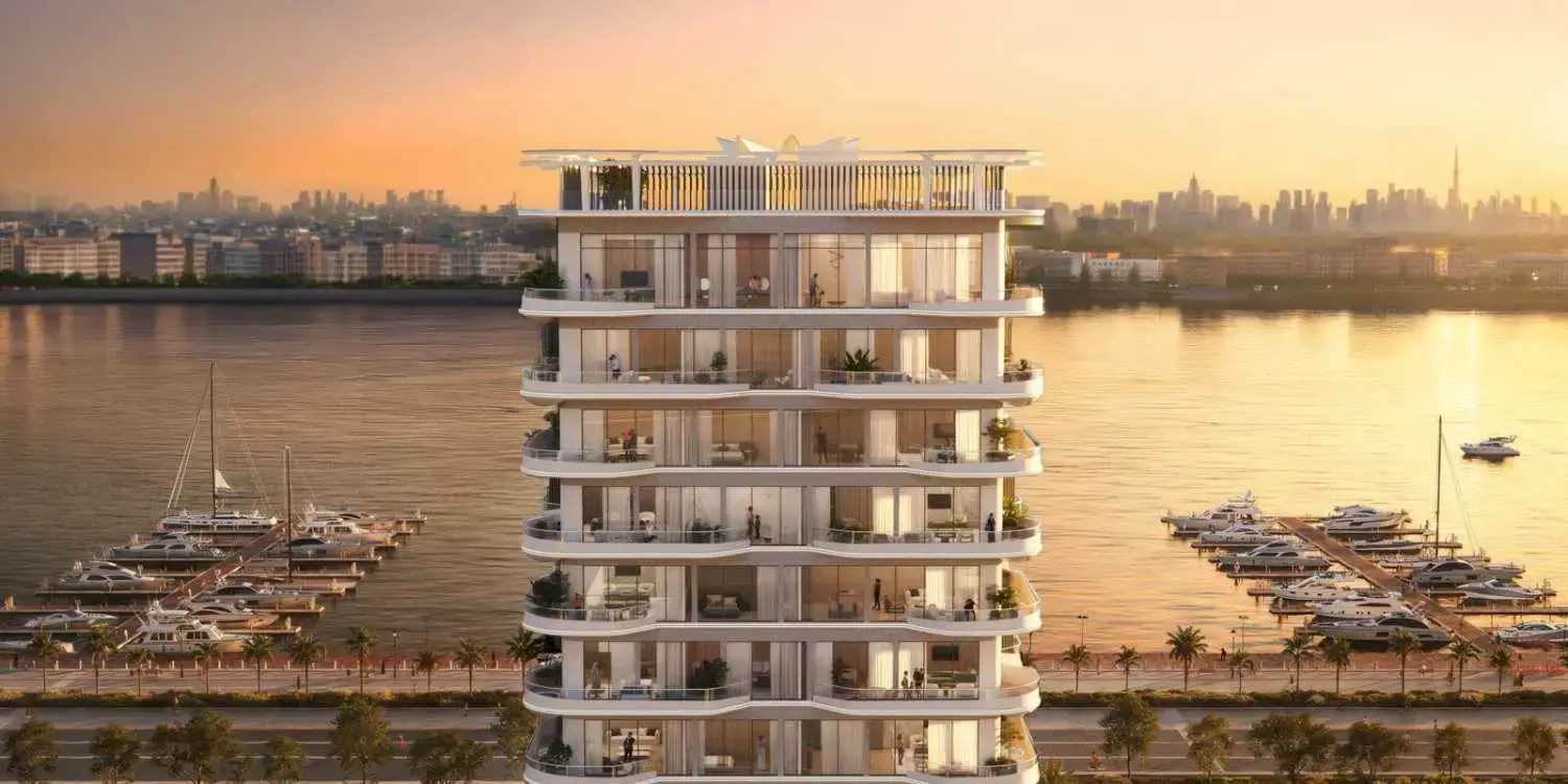 Tower with terraced balconies facing a marina at sunset