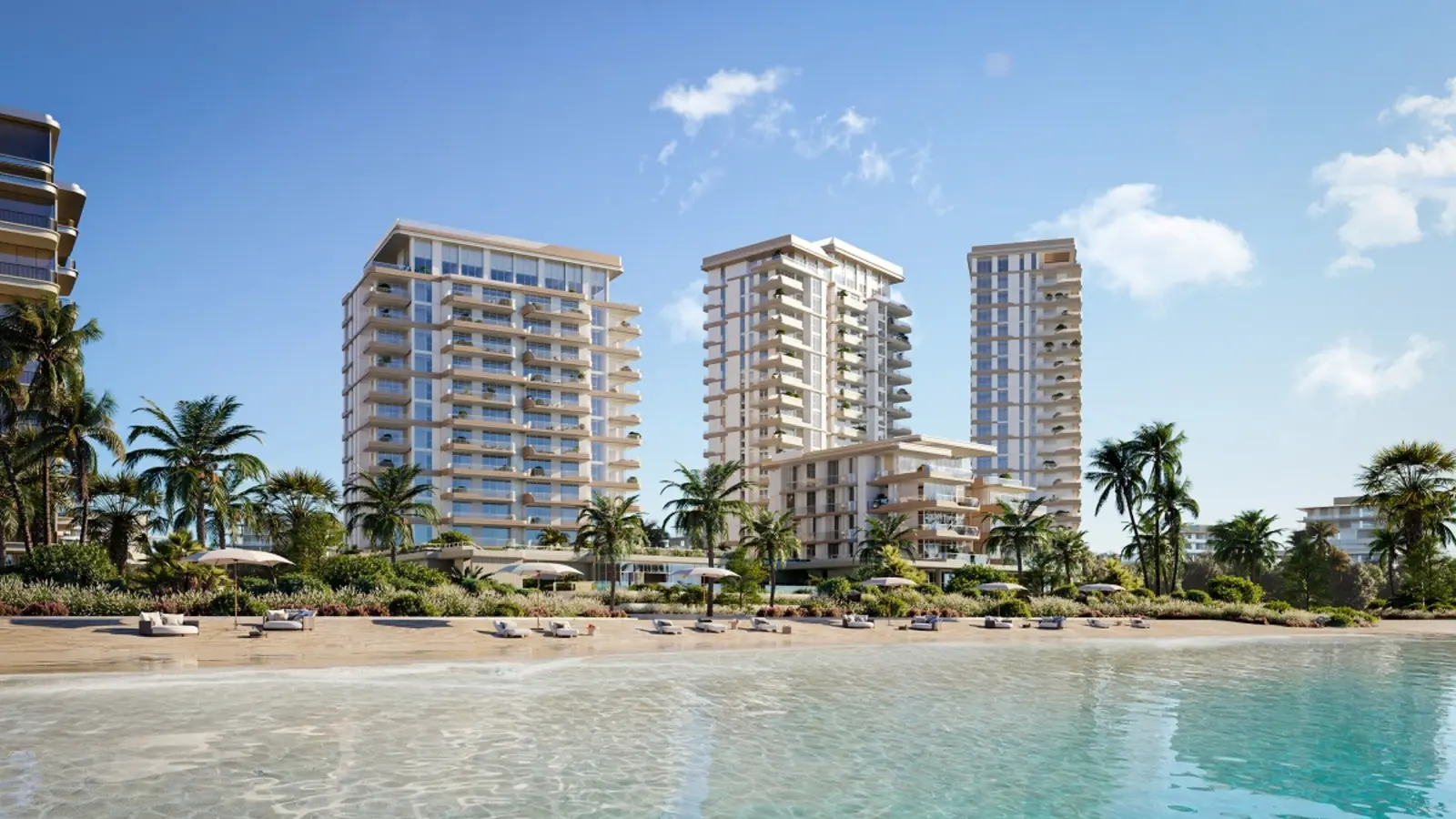 Three buildings seen from the shallow water at the beach