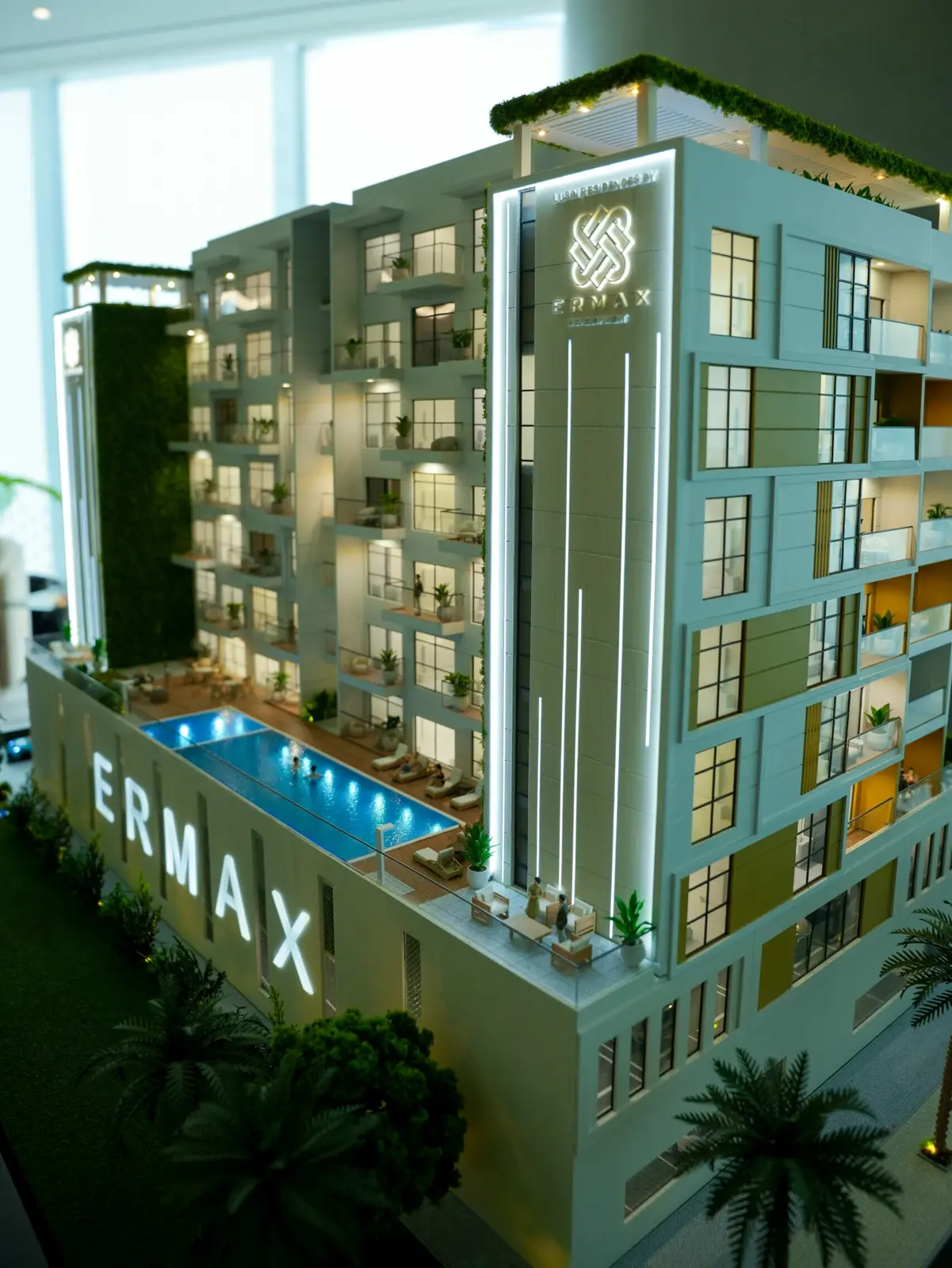 Scale model of building with lit pool deck