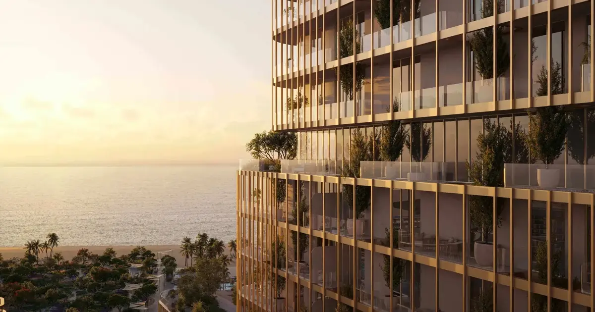 Tower facade with planted balconies facing the sea at sunset