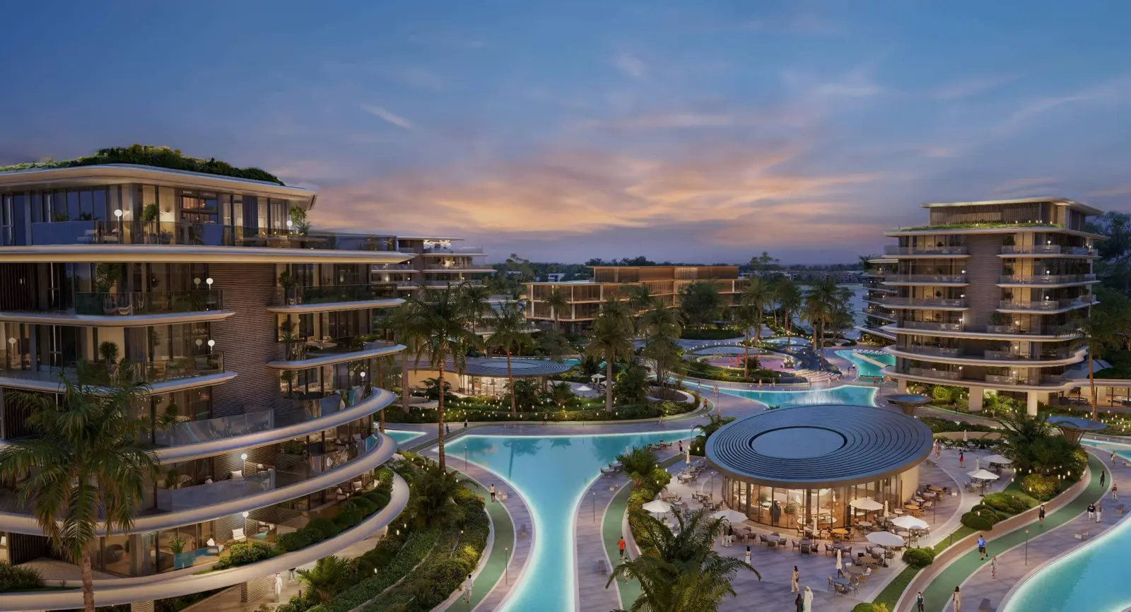 Lagoon pools and pavilion between residential buildings at dusk