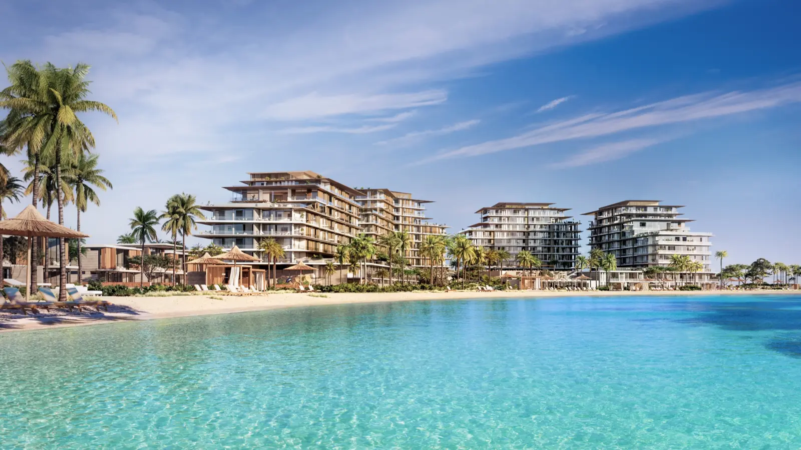 Residential buildings behind beach and turquoise water
