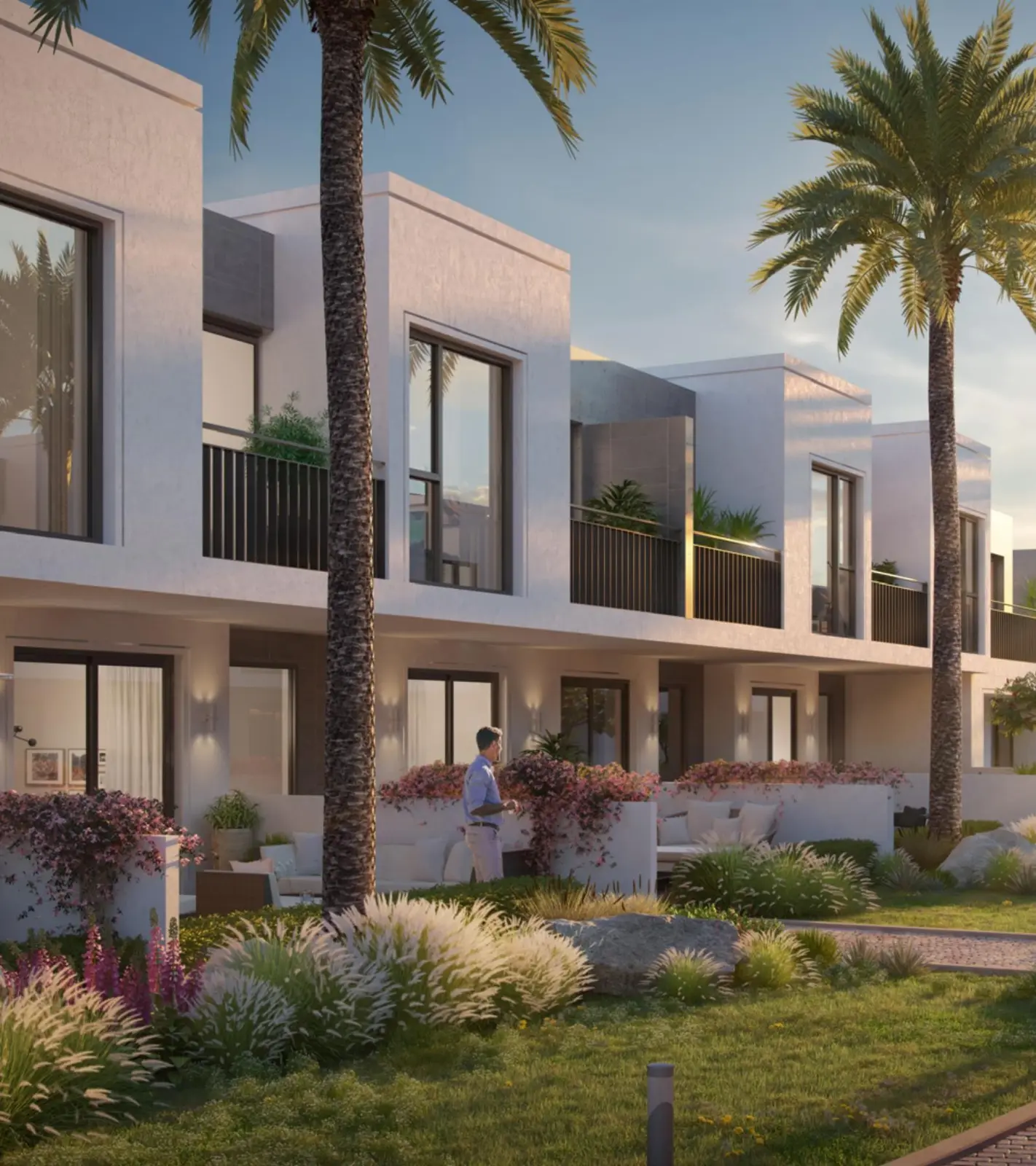 Villa facade at dusk with palms and planting
