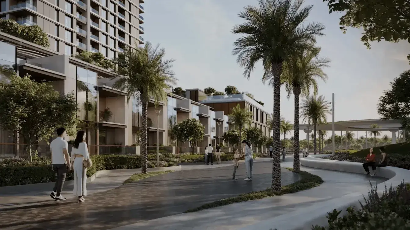 Pedestrians walking along a path beside townhouses and tower