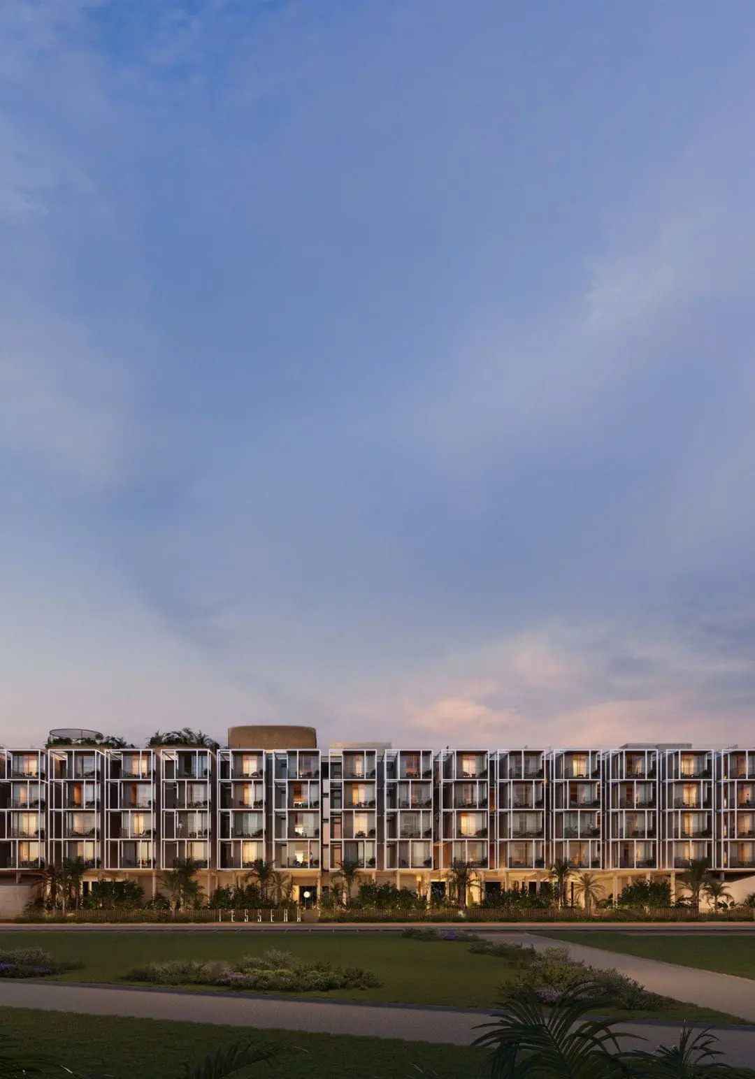 Facade at dusk under a large sky