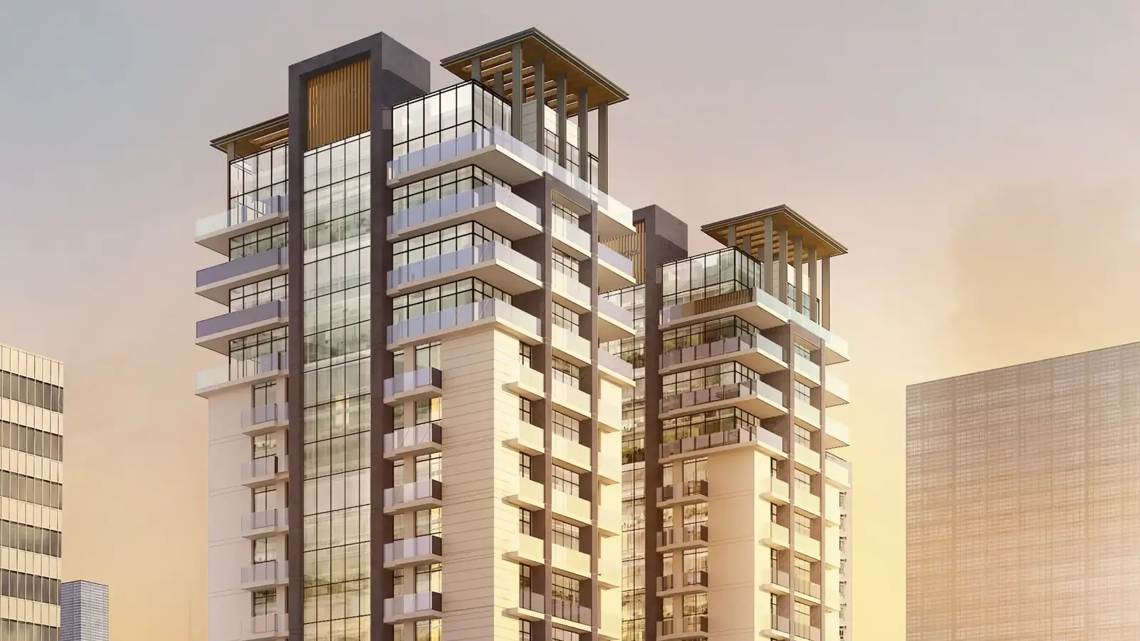 Two residential towers at sunset with glass facades