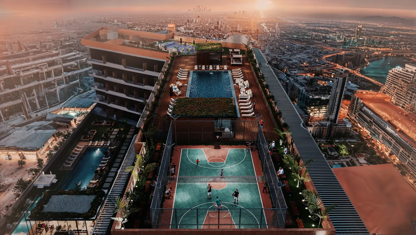 Rooftop pool and sports court seen from above at sunset