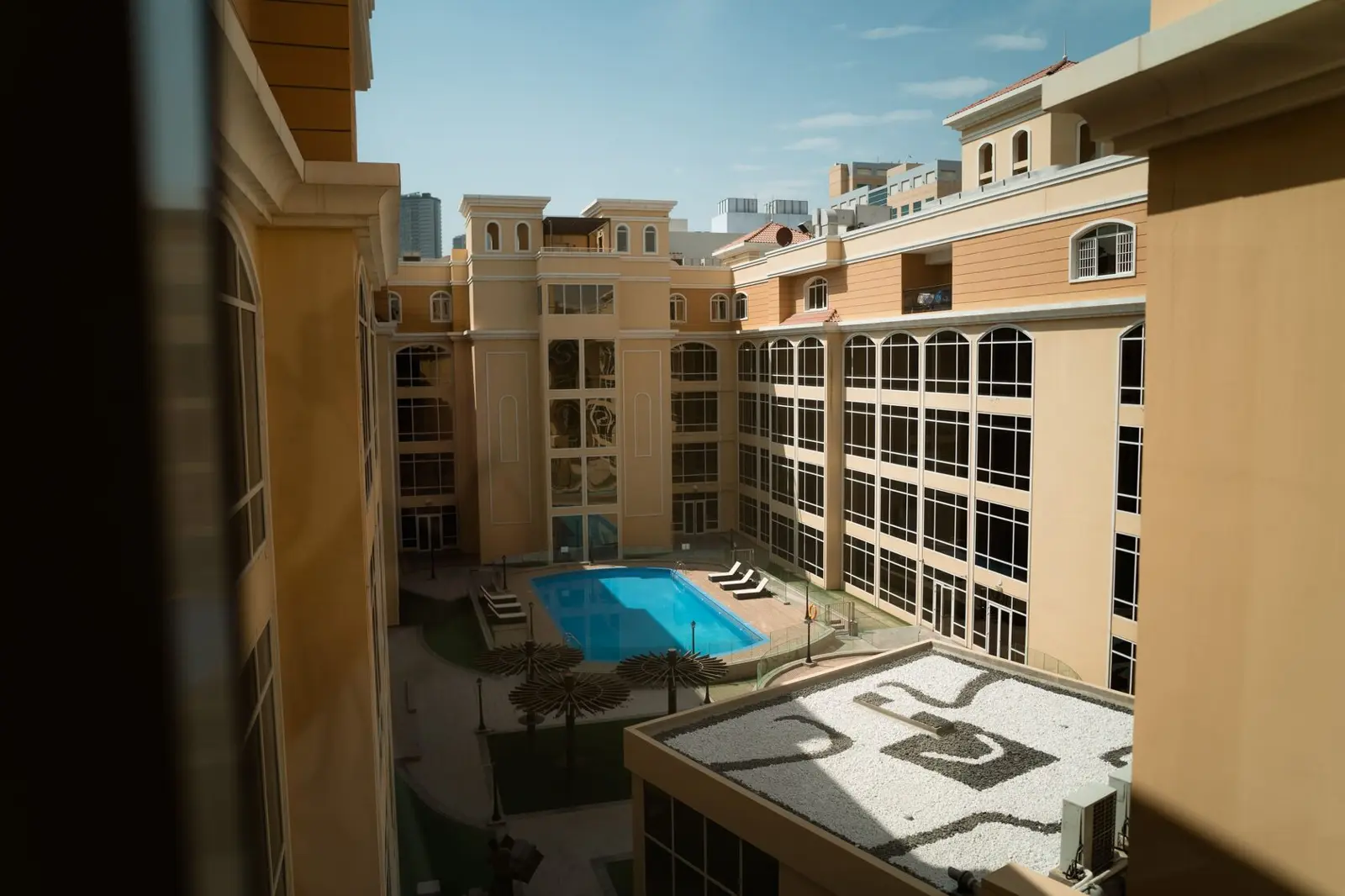Courtyard with swimming pool surrounded by residential buildings