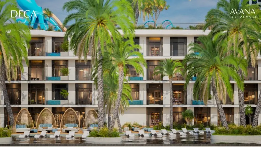 Building facade seen across the pool through palm trees