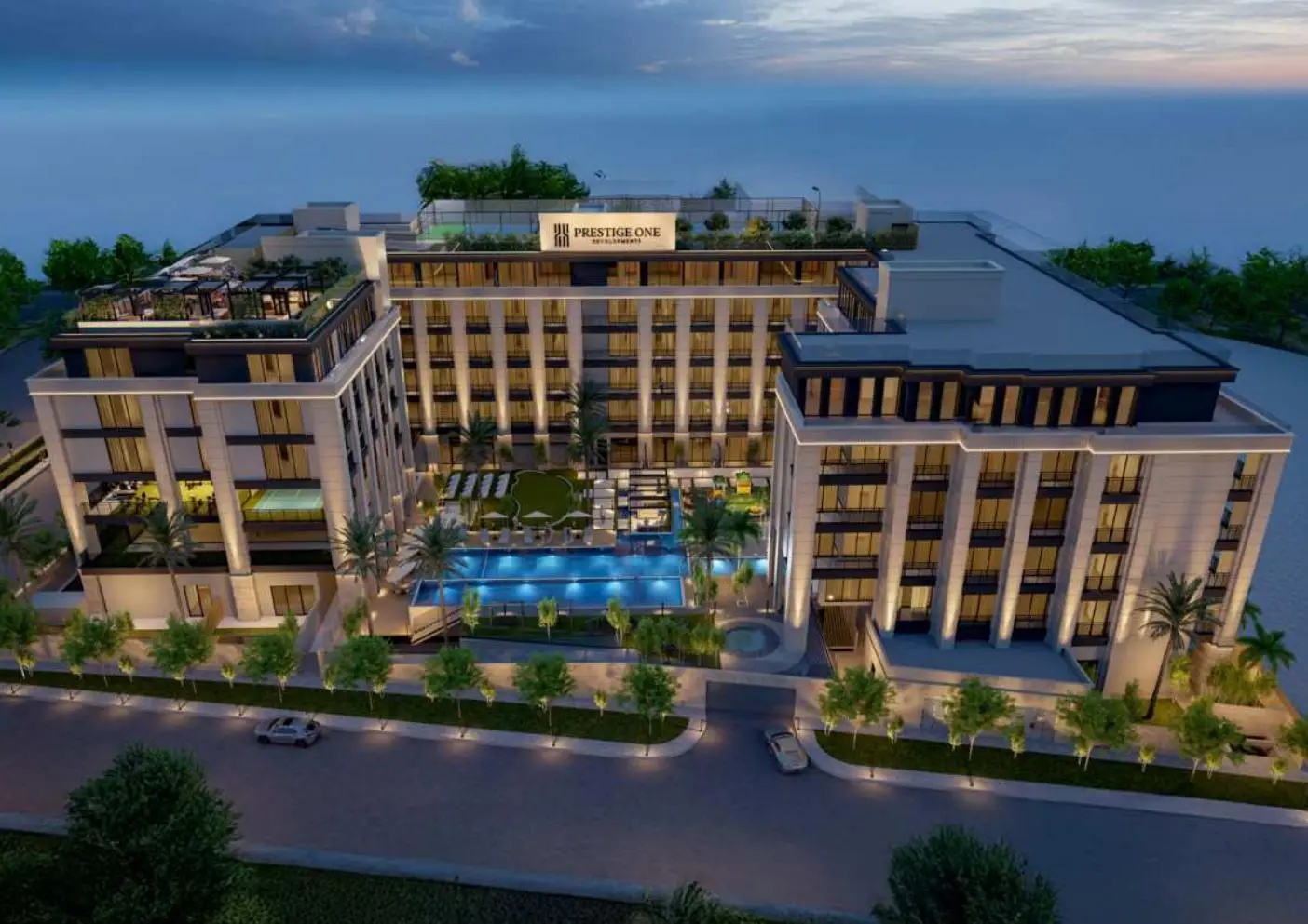 Aerial dusk view of the U-shaped building and courtyard pool
