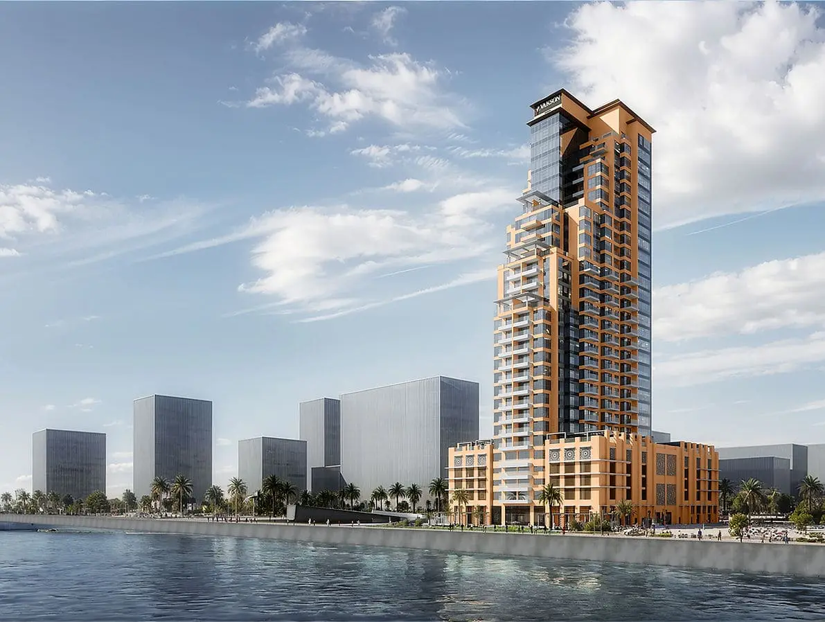 Tall tower with orange and glass facade beside water