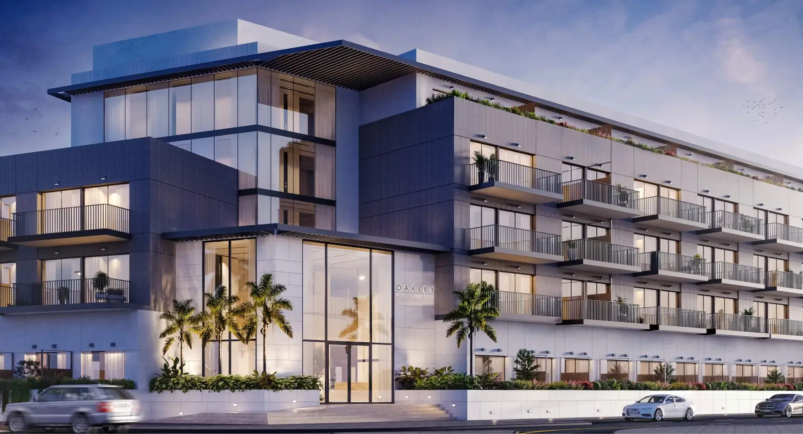 Building facade at dusk with balconies and palms