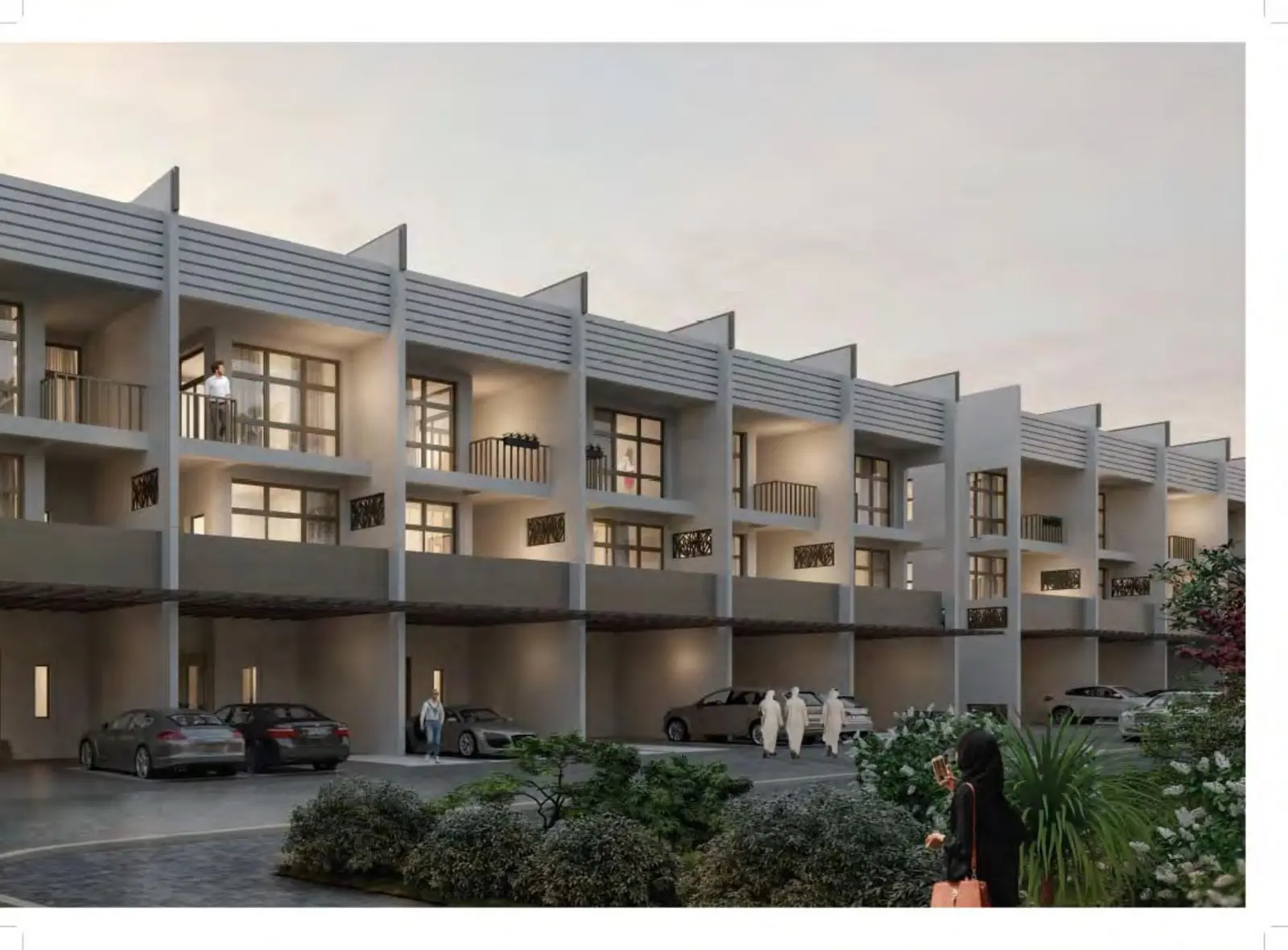 Row of townhouses with covered parking at dusk