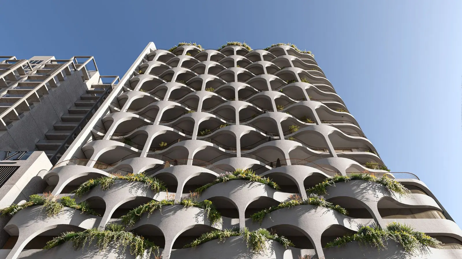 Looking up the arched, planted facade of the tower