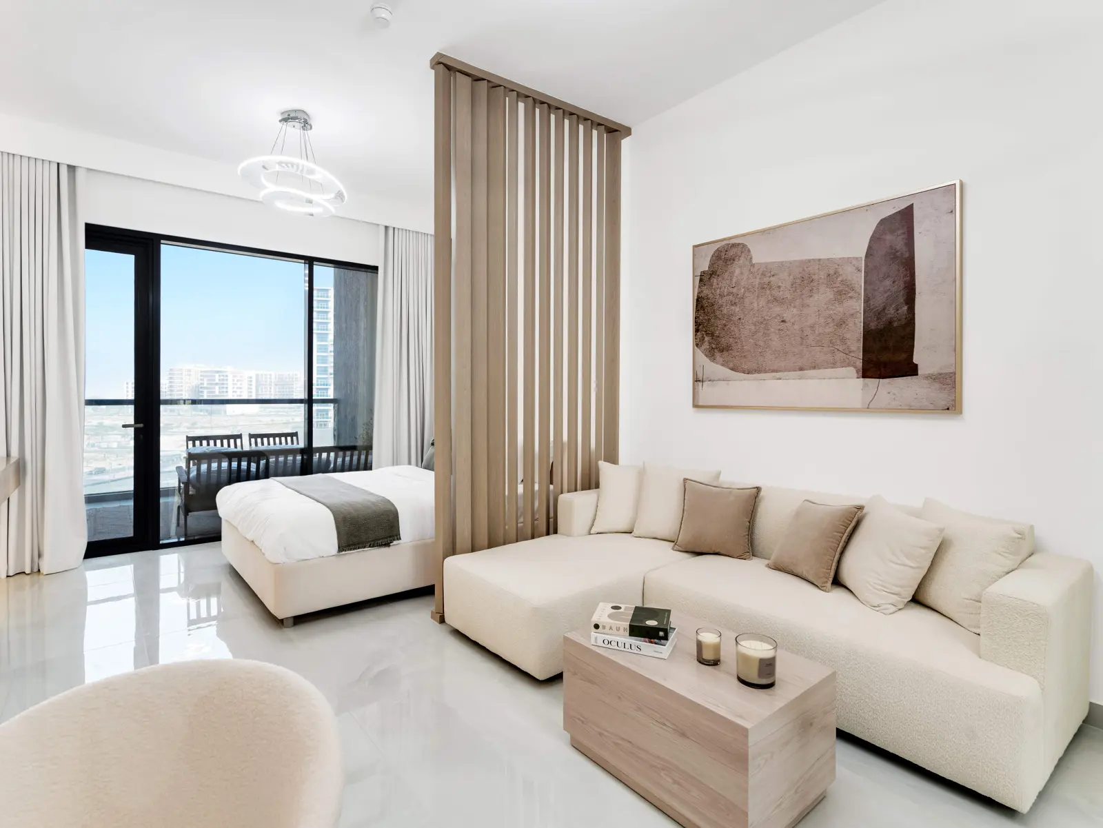 Studio with sofa, wood partition and balcony beyond