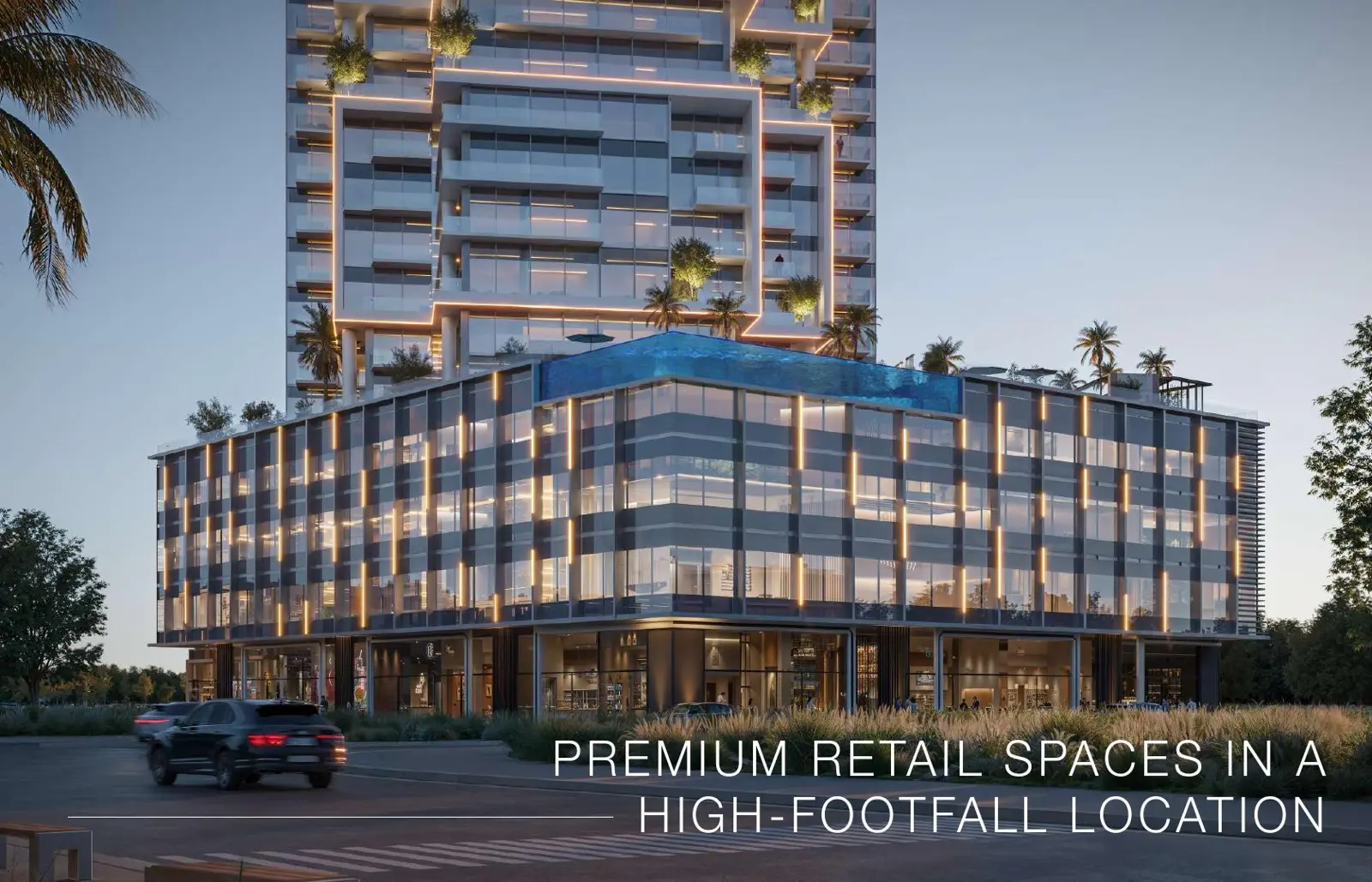 Retail podium with rooftop pool at dusk