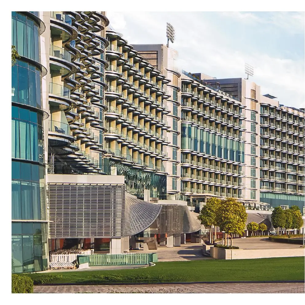 Curved balcony facade of the hotel and lawn