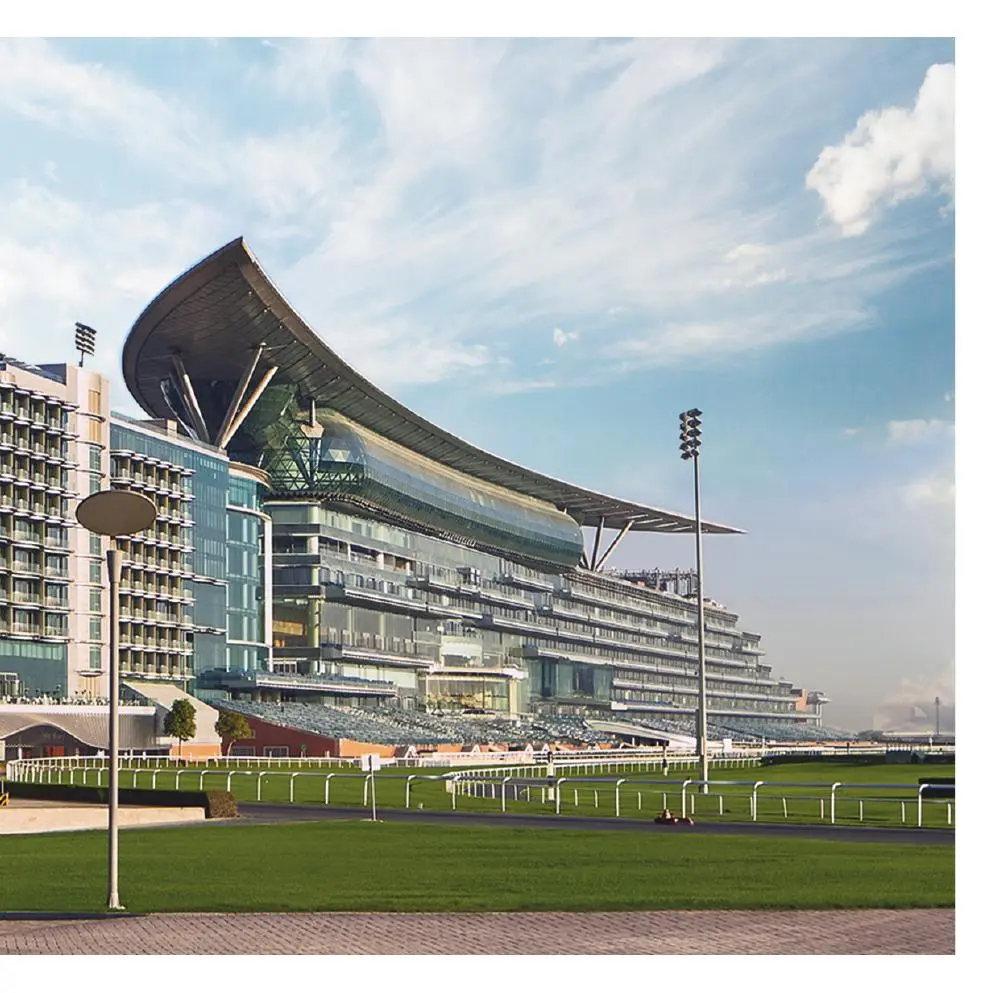Racecourse grandstand with curved roof beside the hotel