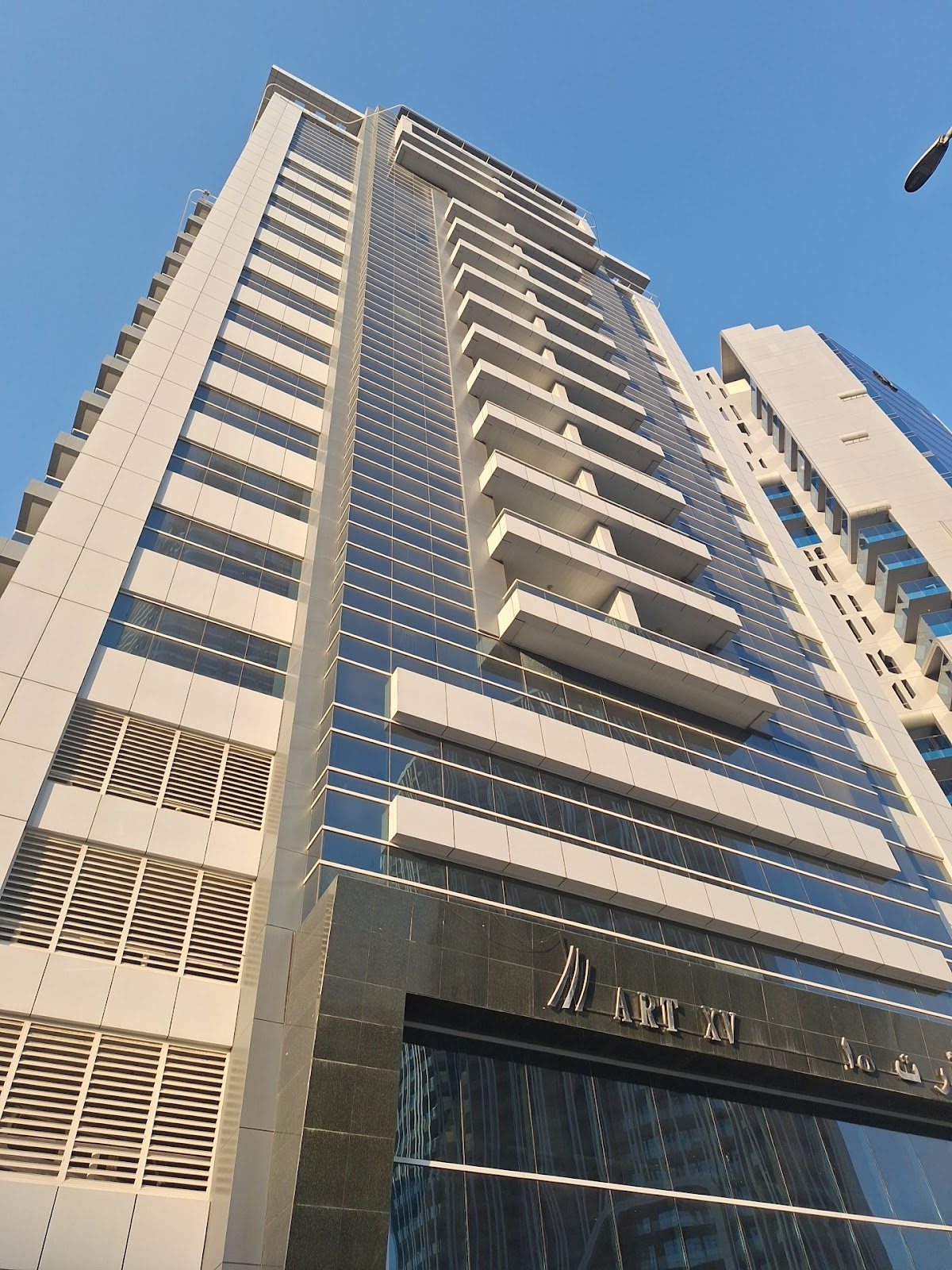 Tower facade seen from street, Art XV sign