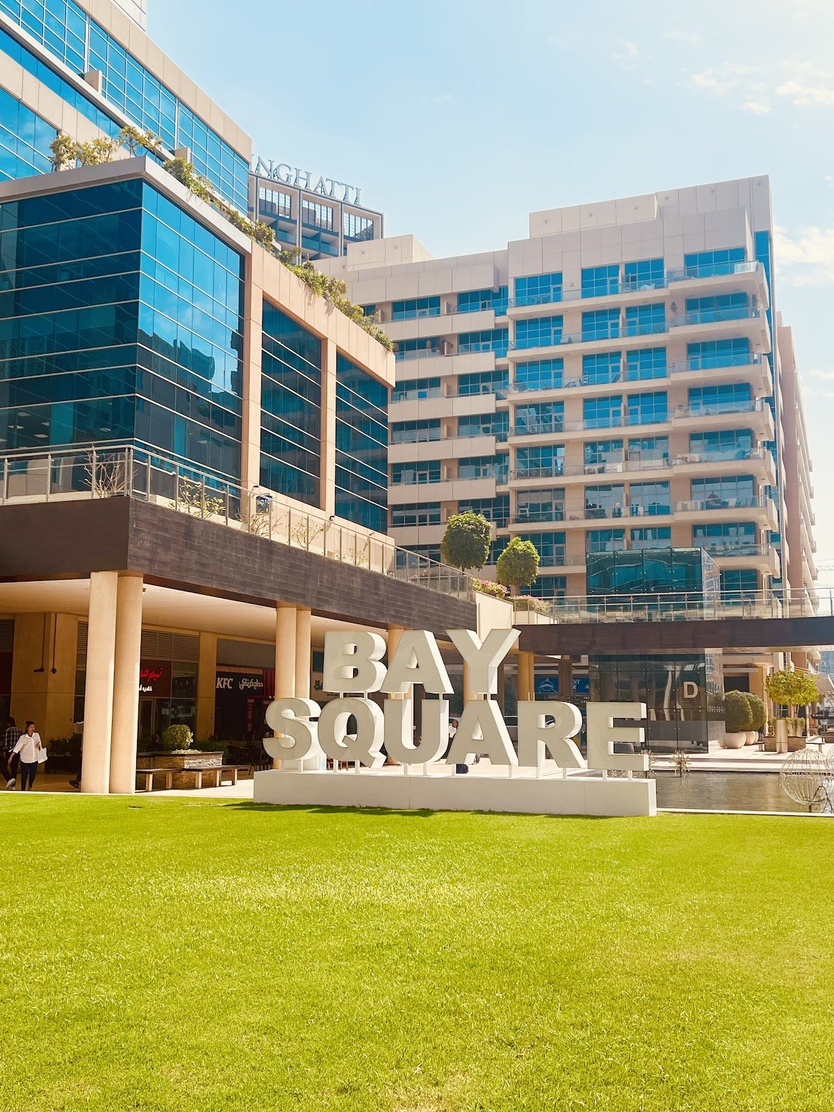 Bay Square sign on lawn before glass buildings