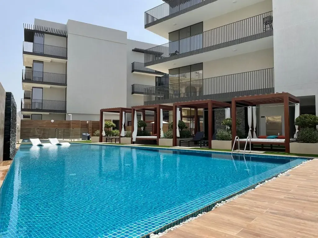 Project picture: Q Gardens Boutique Residences Block B. outside of the Q Gardens Boutique Residences project with shared pool (project, not Block B specifically; 1024 px wide)