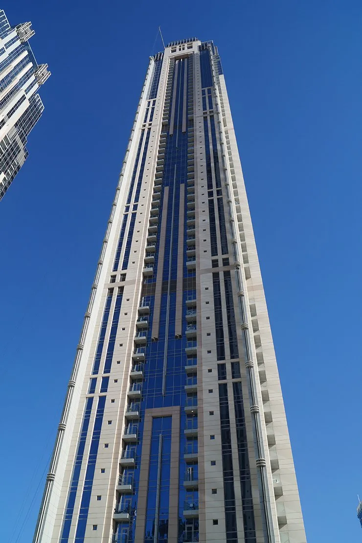Upper facade with balconies and blue glazing