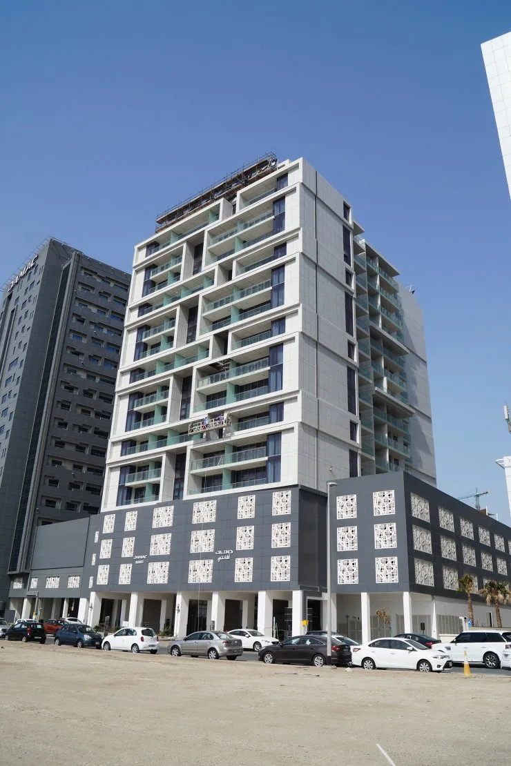 Full tower from street with podium and patterned panels