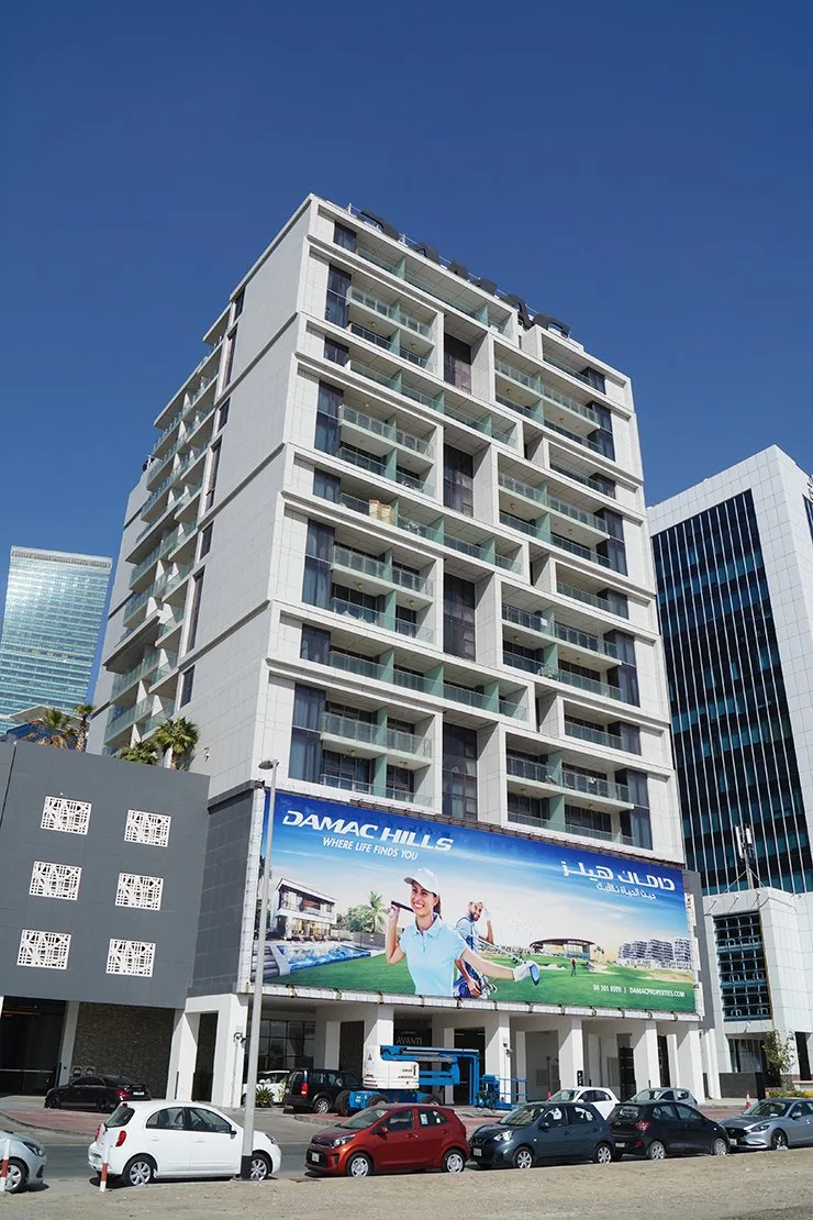 Tower from ground, white facade with green balconies