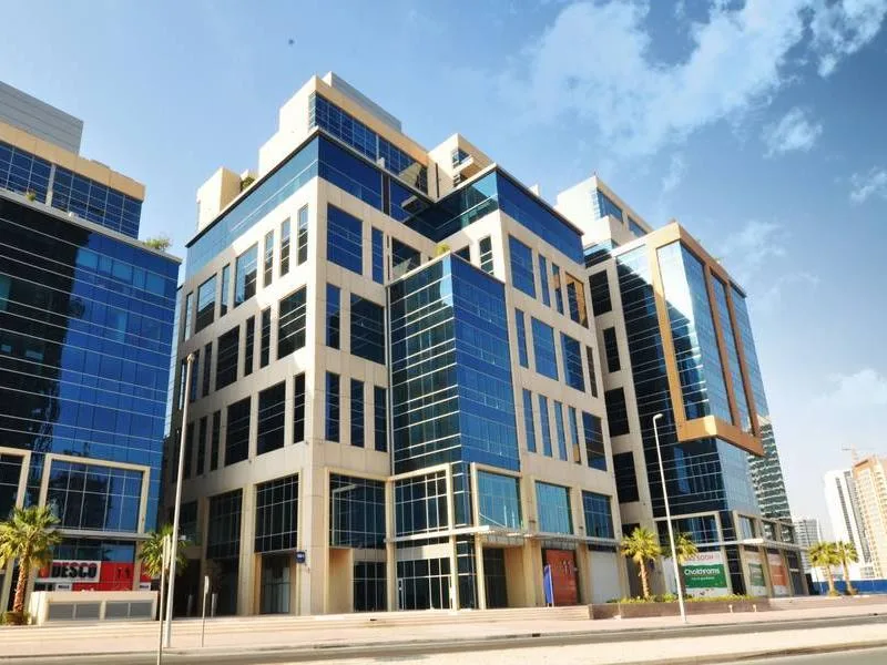 Full building with stepped crown and blue glass corner