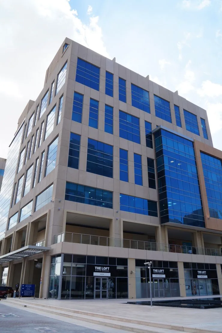 Beige and blue-glass office building from street corner