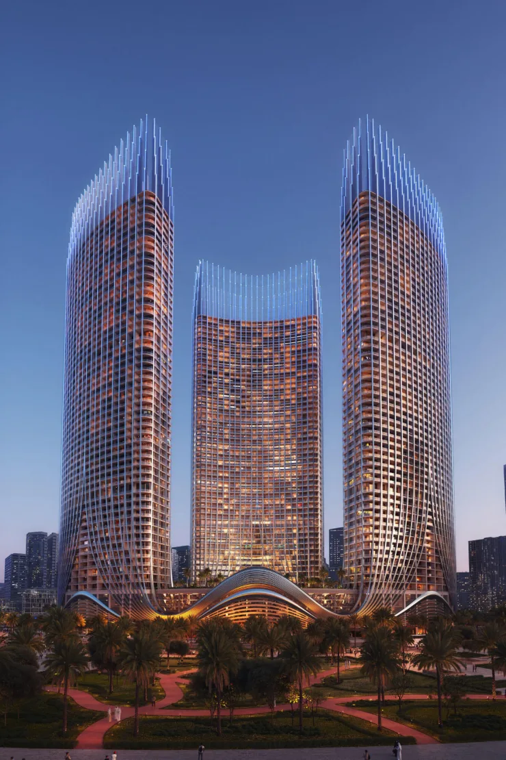 Three towers at dusk with the wave podium and gardens