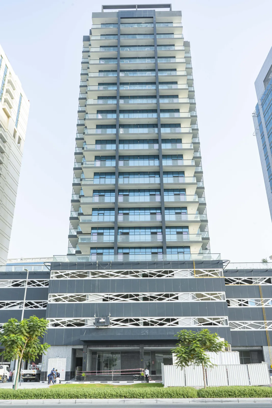 Full-height front view with dark podium and lattice panels