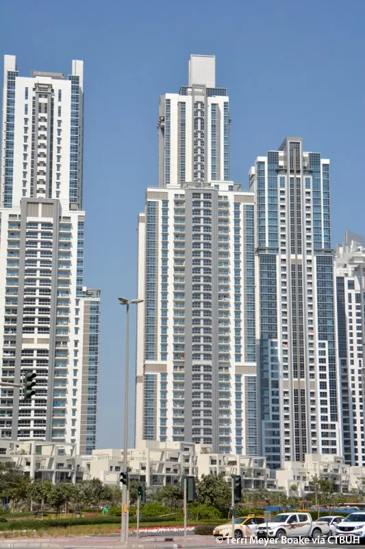 Central white tower with balconies and boxy crown