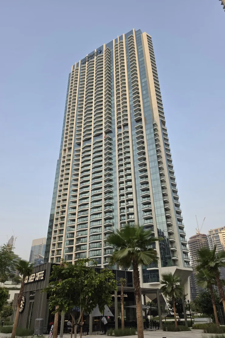 Completed tower seen from ground with balconies and glass