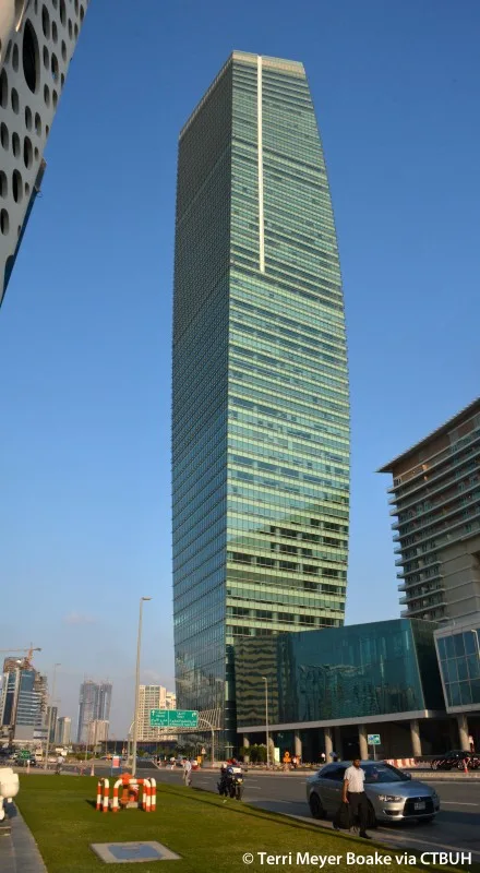 Full-height glass tower seen from street level