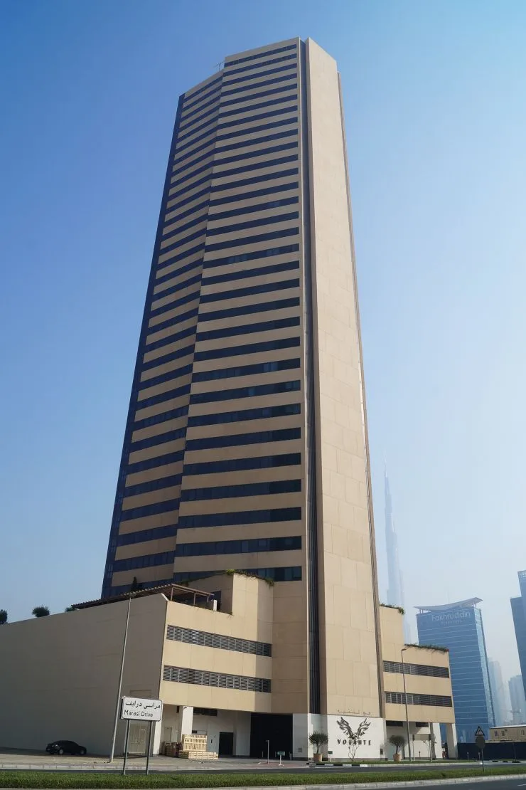 Beige and dark glass striped tower from street